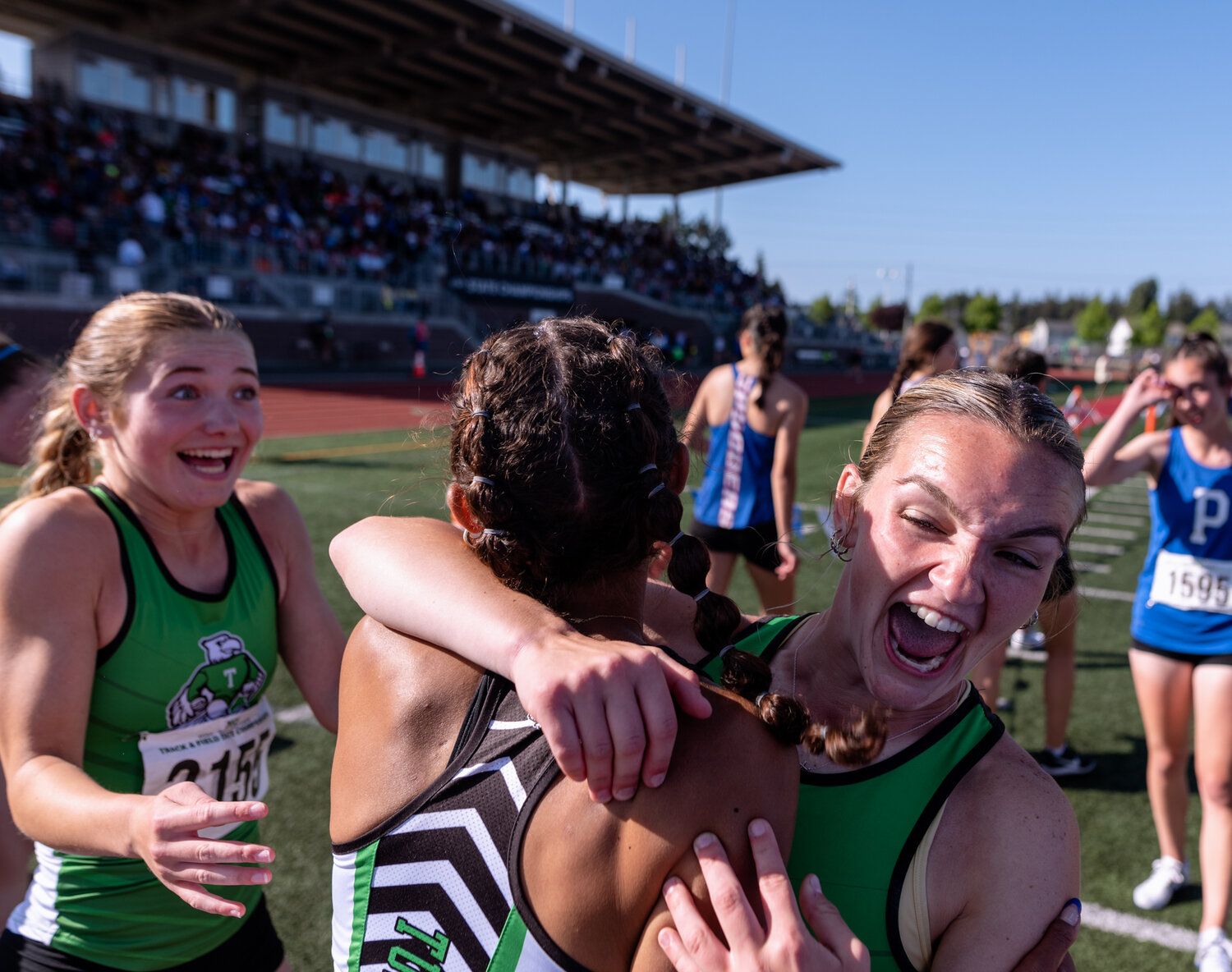 Tumwater’s Reese Heryford hugs Ava Jones in excitement of winning the 2A girls team title following their victory in the 4x400 relay at the WIAA 2A/3A/4A State Track and Field Championships on Saturday, May 27, 2023, at Mount Tahoma High School in Tacoma. (Joshua Hart/For The Chronicle)
